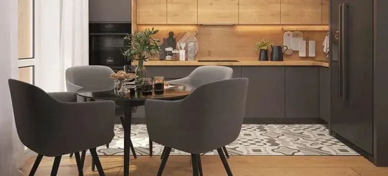 Modern kitchen with gray dining chairs and wooden cabinets