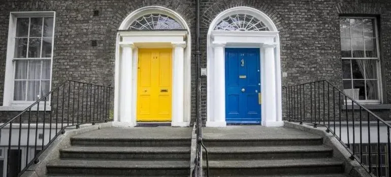 Yellow and blue front doors of brick townhouses