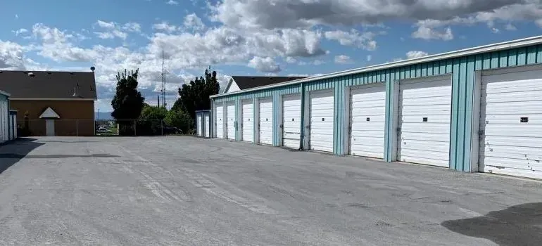 Row of self-storage units with white roll-up doors