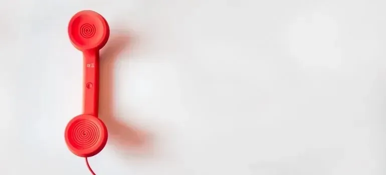Red retro telephone handset on white background