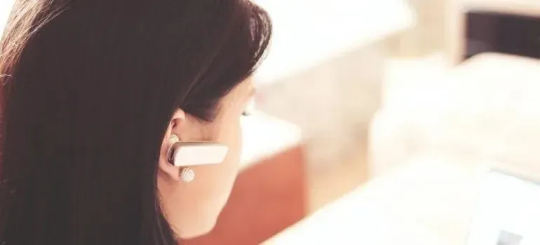 Woman wearing wireless earpiece working as support agent