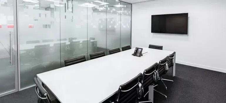 Empty modern conference room with long white table