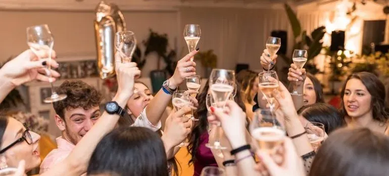 Crowd raising champagne glasses at party