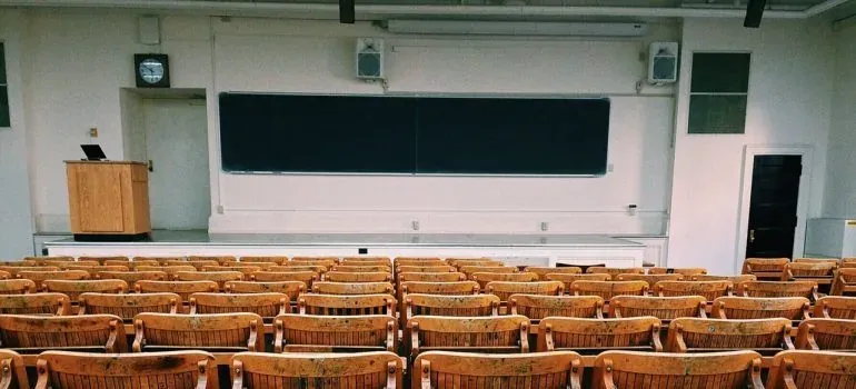 Empty lecture hall with wooden seats