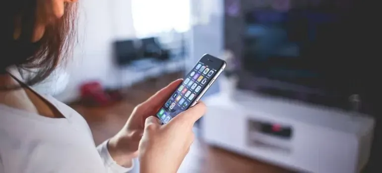 Woman browsing smartphone apps in living room