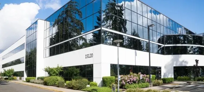 Modern glass office building numbered 15120 with landscaping
