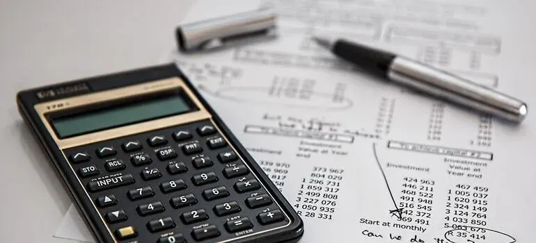 Calculator and pen on financial papers