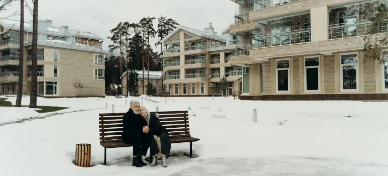 Elderly couple on snowy bench