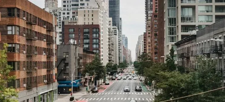 New York City street with apartment buildings and traffic