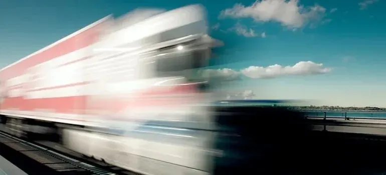 Motion-blurred truck speeding on coastal highway, unreadable livery