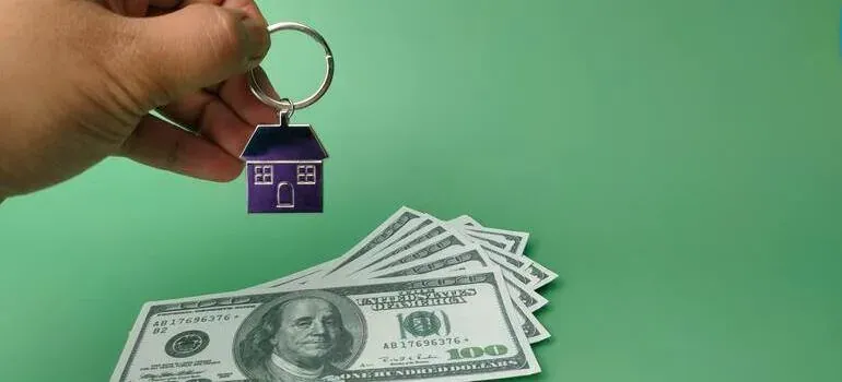 House keychain and hundred dollar bills