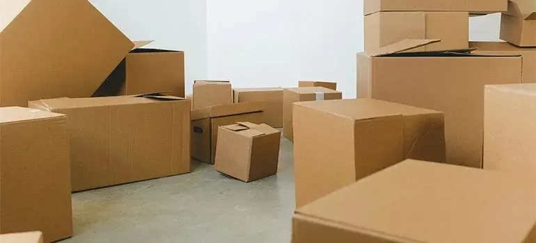 Plain cardboard boxes stacked in an empty room