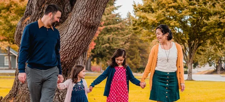 Family of four walking in park