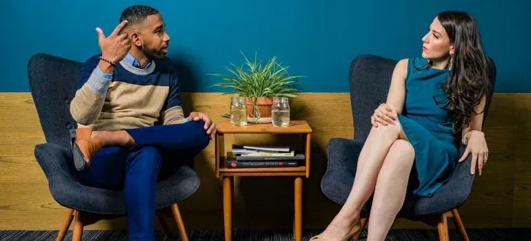 Man and woman conversing in chairs