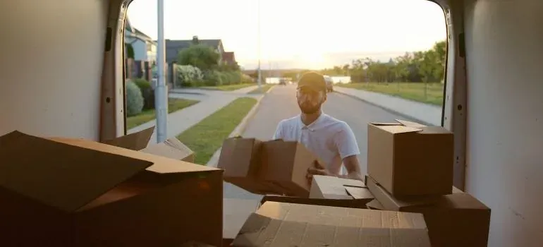 Movers carrying boxes outside a New Jersey home