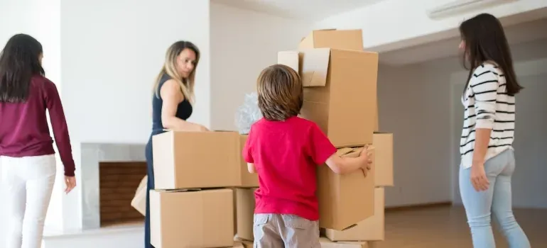 Family stacking boxes in living room