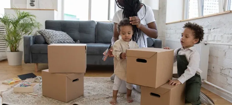 Parent and two kids with boxes