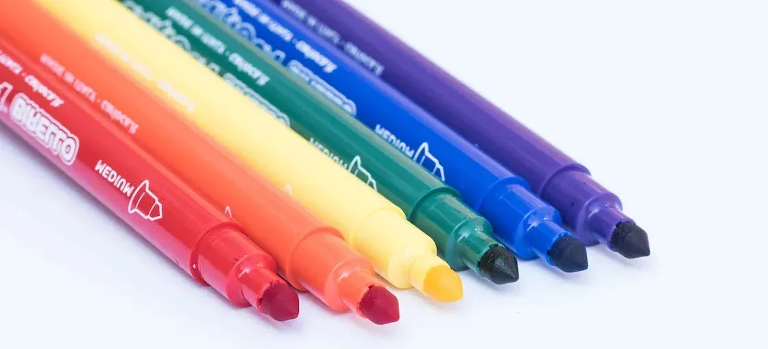 Colorful marker pens close-up on white