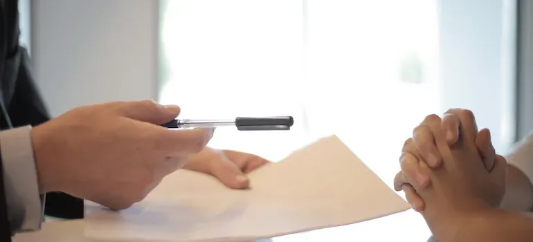 Businessman offering pen over document