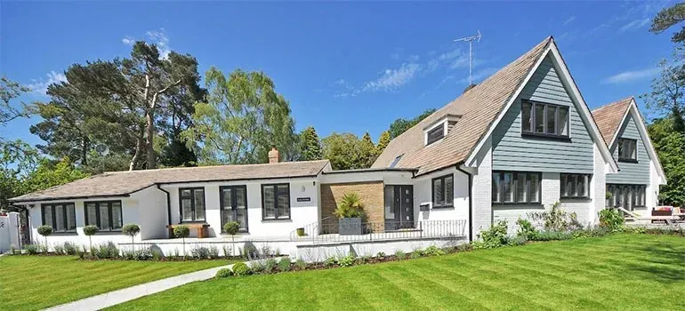 Modern white house with gables and manicured lawn