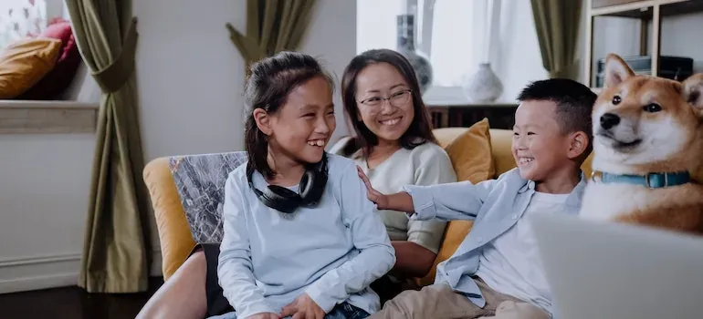 Mother, kids and dog on sofa