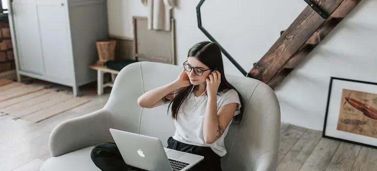 Woman with laptop on sofa