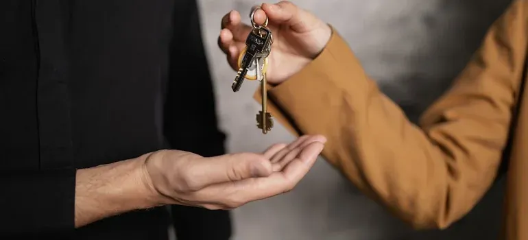 Hands exchanging house keys closeup