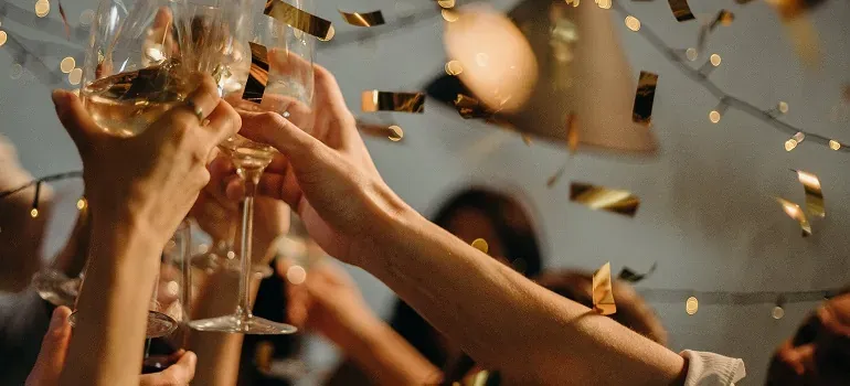 Champagne toast with confetti at party