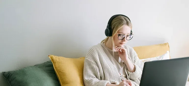 Woman with headphones using laptop