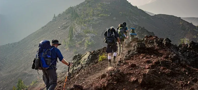 Hikers with backpacks on mountain ridge