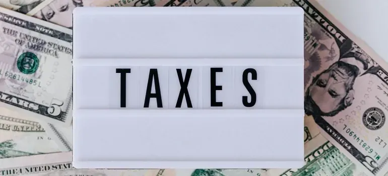 TAXES letterboard over dollar bills