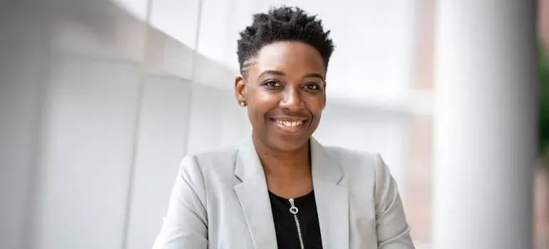 Smiling businesswoman in gray blazer portrait