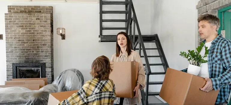 Family carrying plain boxes indoors