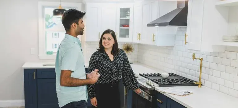 Man and woman talking in kitchen