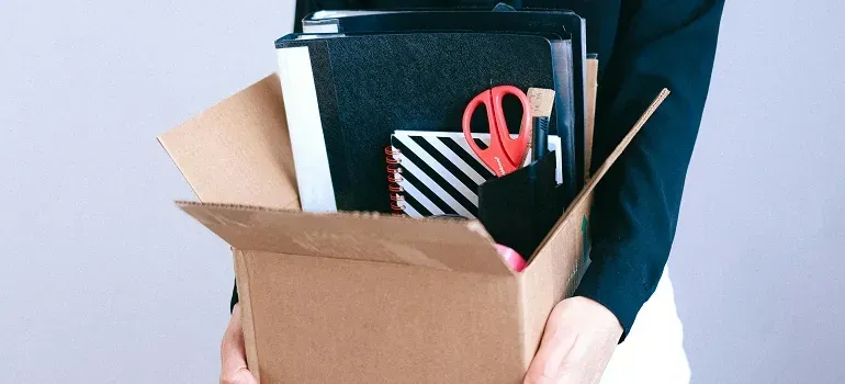 Person carrying box of office supplies