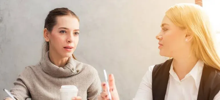 Two women talking over coffee