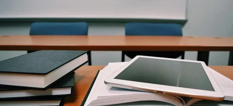 Books and tablet on classroom desk