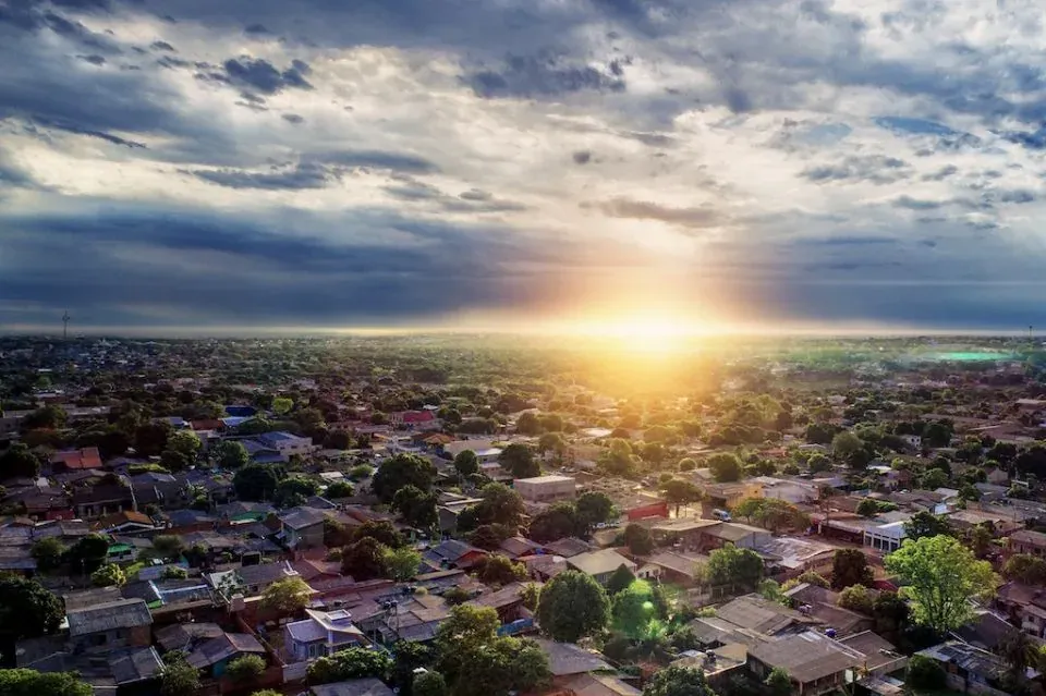 Aerial sunset over sprawling suburb