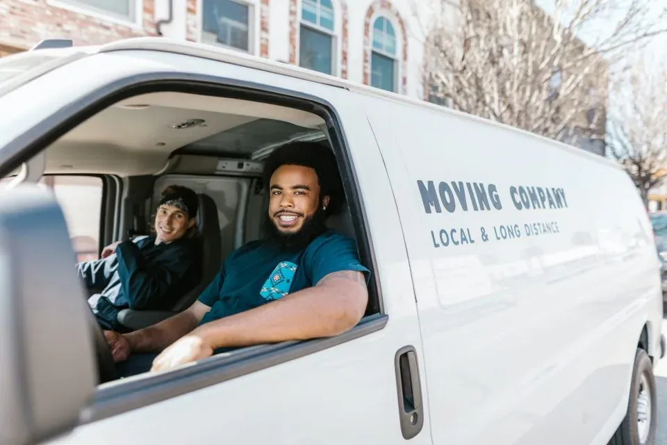 A New Jersey moving crew carrying boxes outside an apartment building
