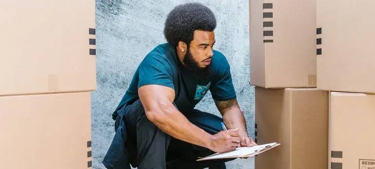 Movers carrying boxes into a New Jersey home