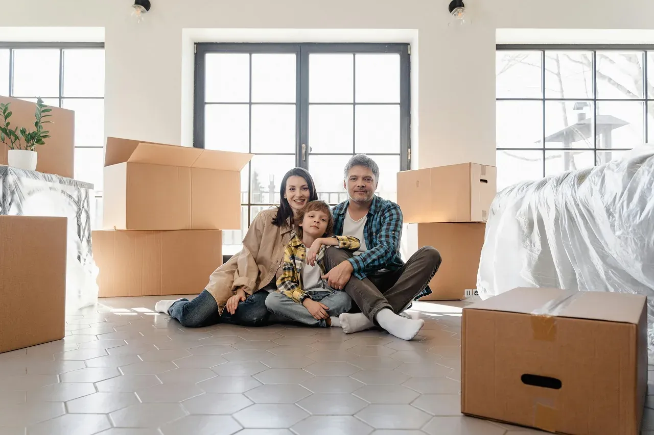 Family unpacking moving boxes in their new New Jersey home