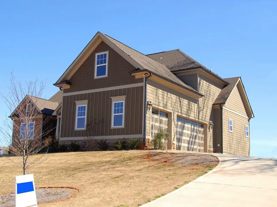 Suburban house with blank yard sign