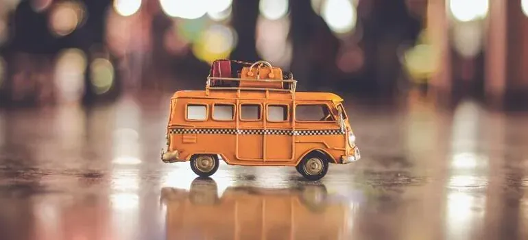 Toy orange van with luggage