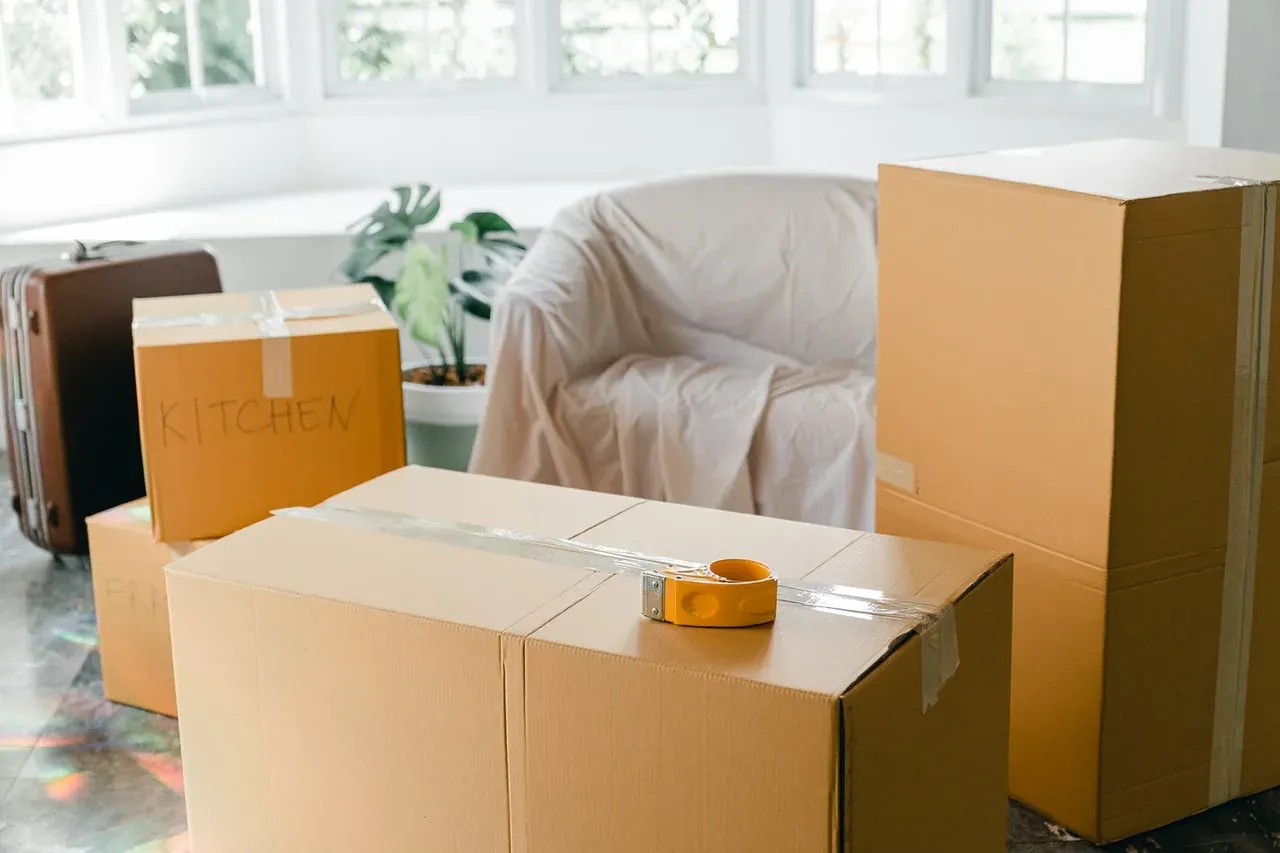 Movers wrapping and lifting bulky furniture in New Jersey