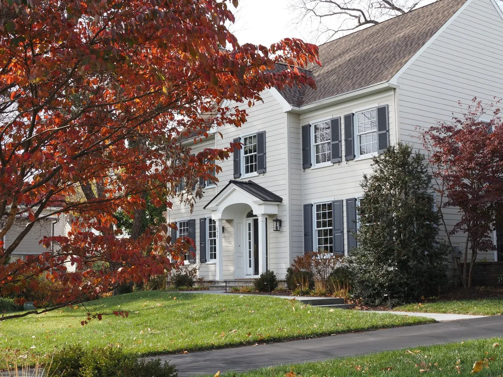 Movers carrying boxes into a suburban Oakland, New Jersey home