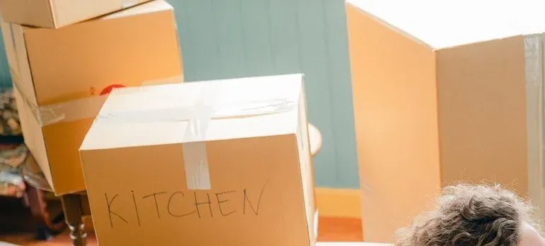 Cardboard boxes labeled kitchen indoors