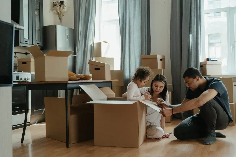 Movers unpacking boxes in a New Jersey home after a long-distance move
