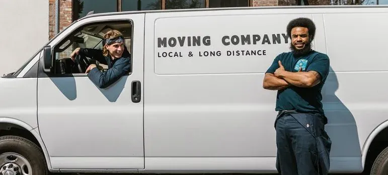 Movers carrying boxes into a home in Paterson, New Jersey